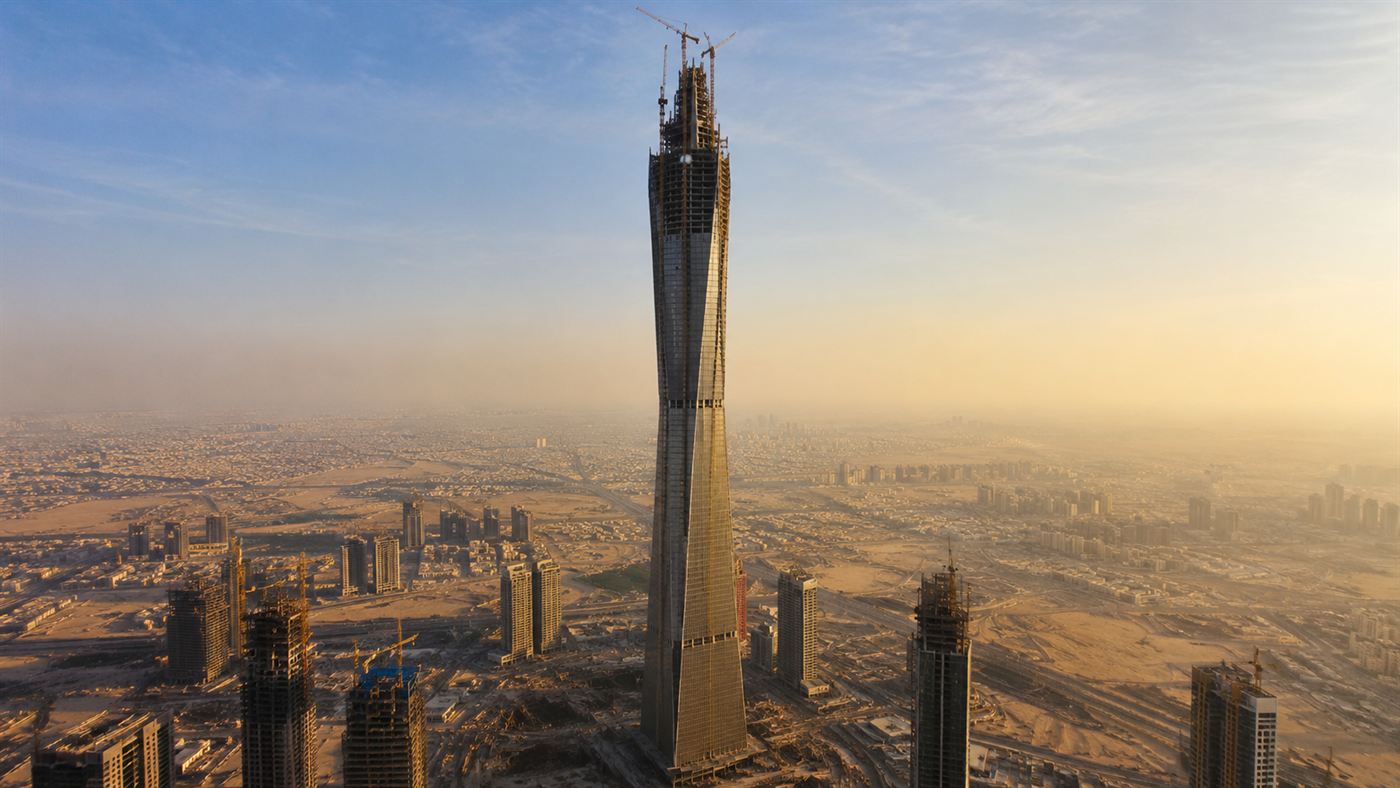 The tapering Jeddah Tower under construction, a needle-like skyscraper rising far above the city with cranes at its top