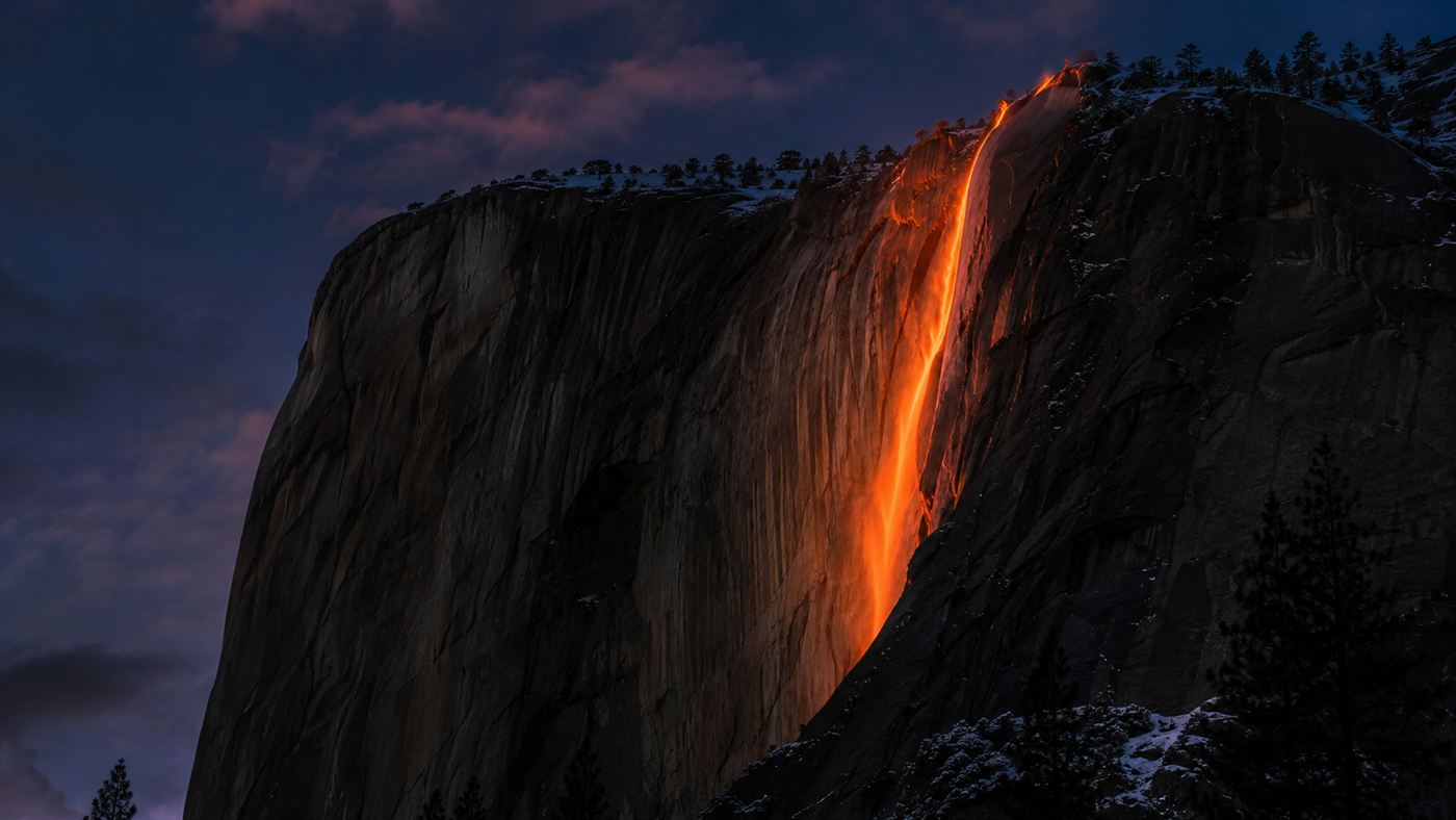 The natural Yosemite firefall, Horsetail Fall glowing bright orange like molten lava as the setting February sun lights it against the dark cliff of El Capitan