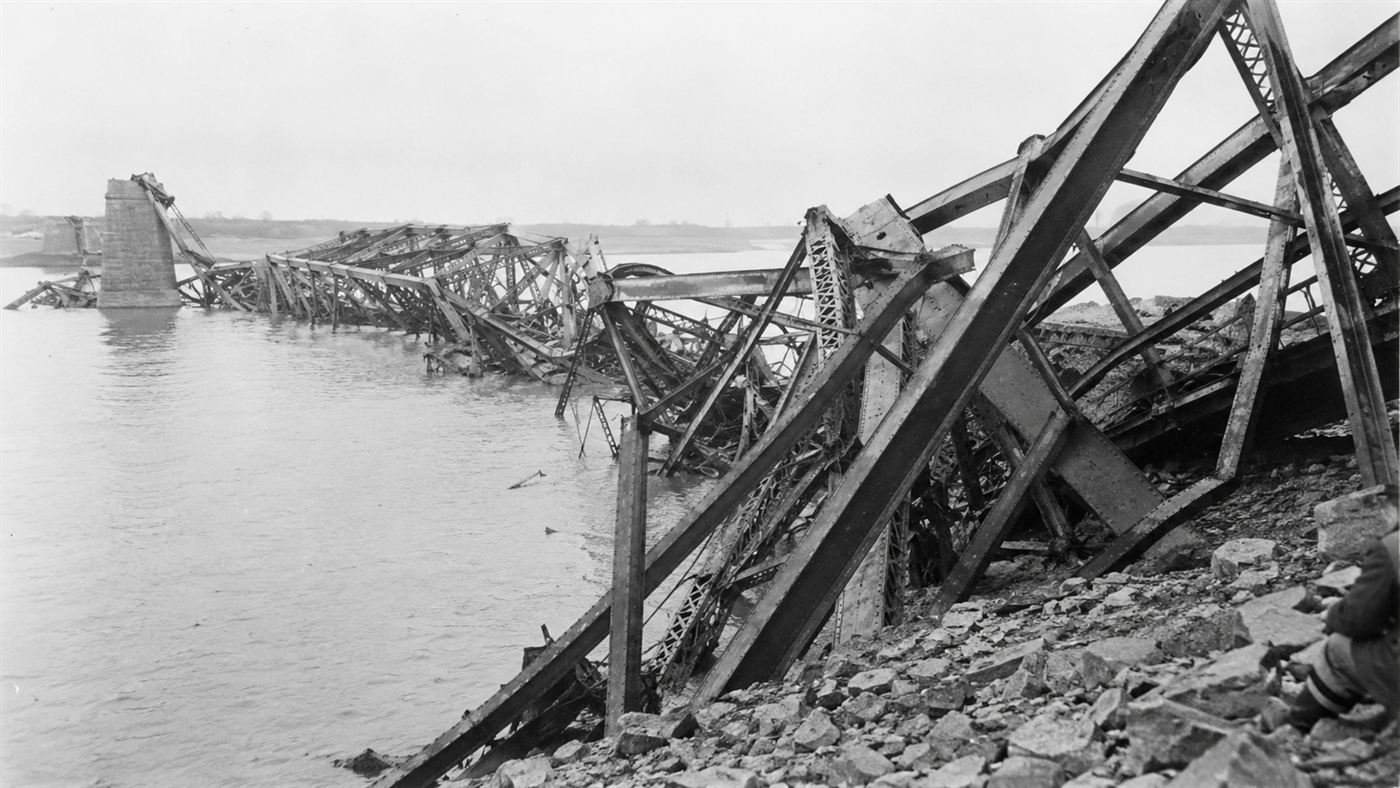 Twisted wreckage of steel girders from the 1907 Quebec Bridge collapse lying in and along the St. Lawrence River