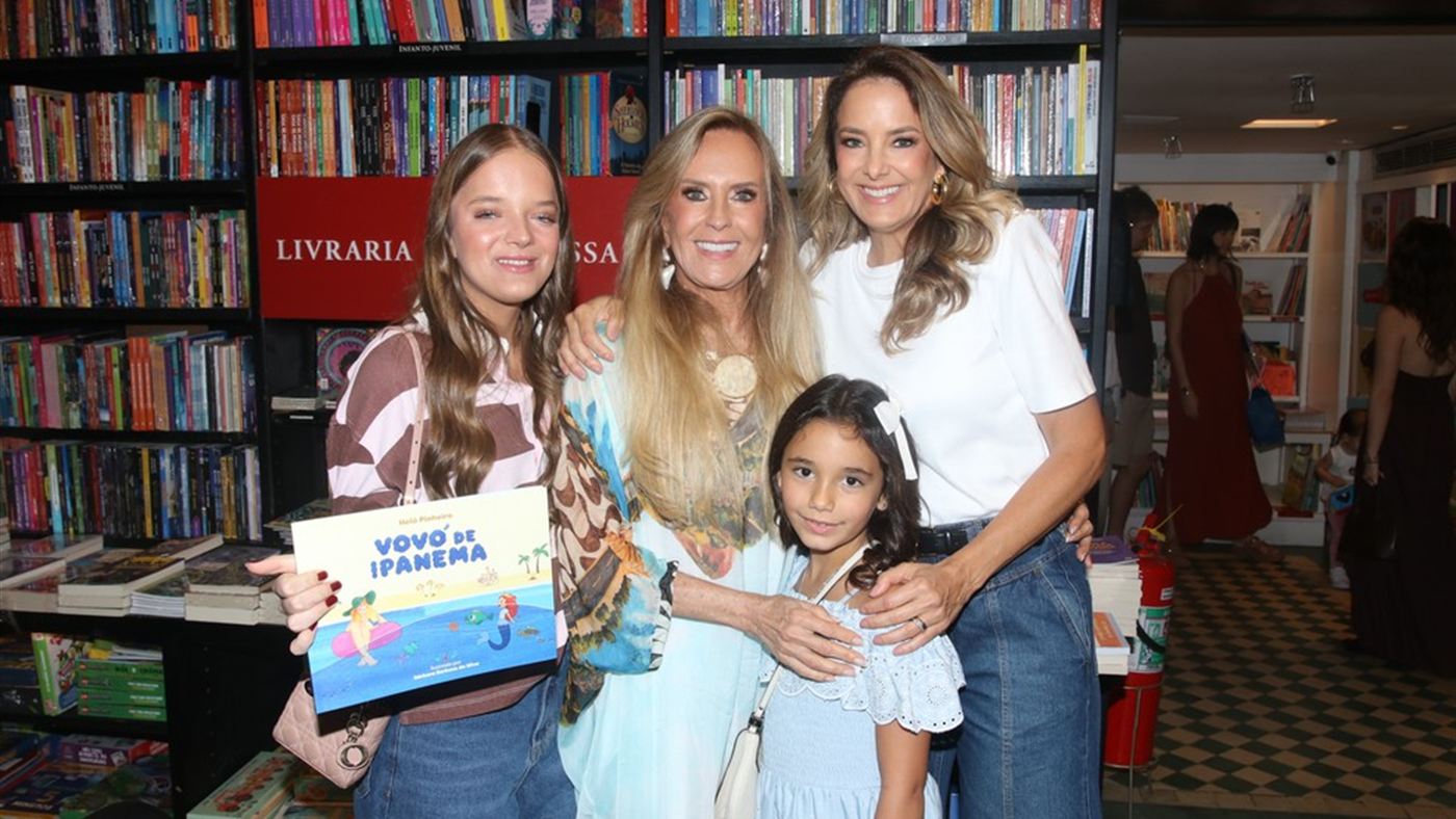 Helô Pinheiro posa com o livro Vovó de Ipanema ao lado de familiares na livraria