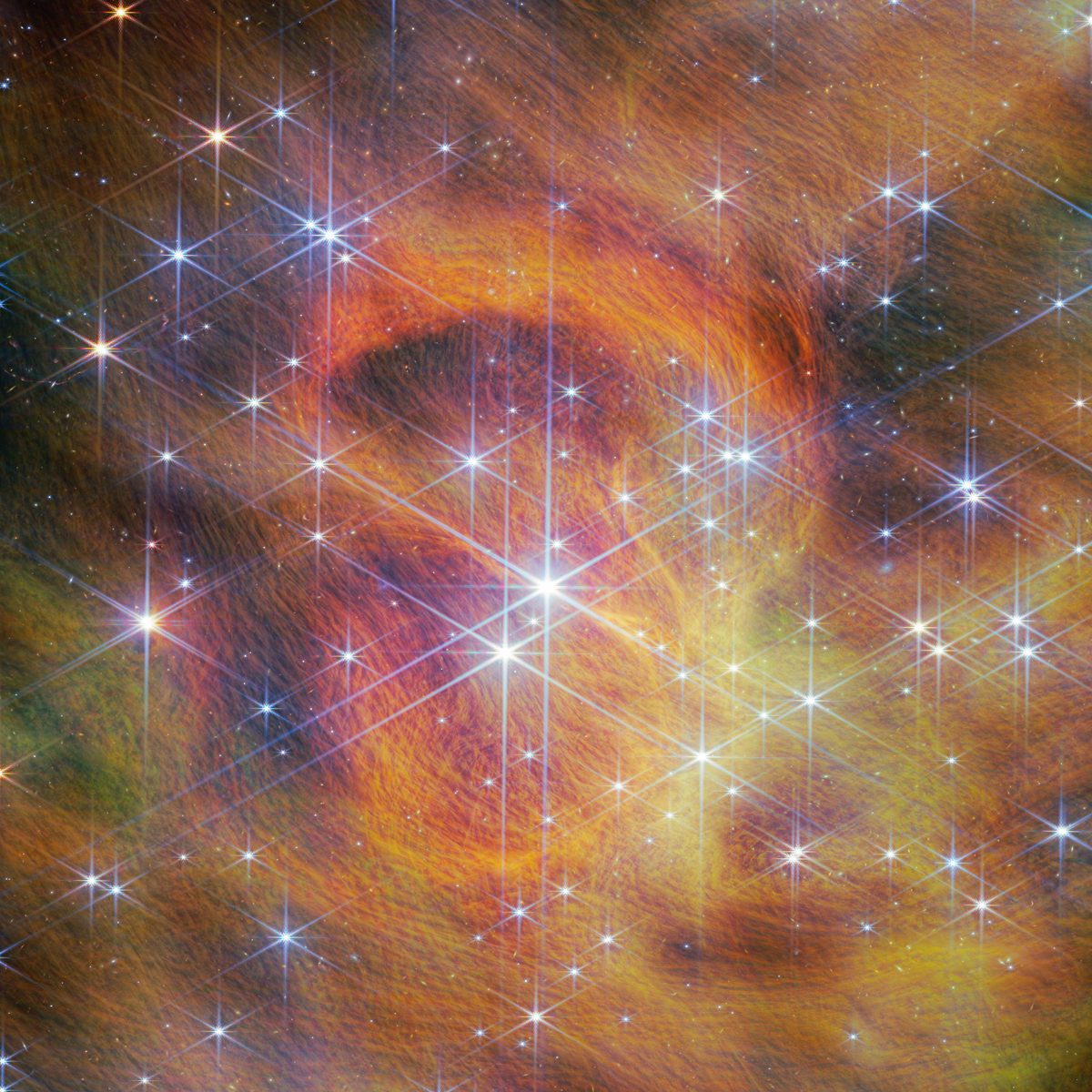 Centro do aglomerado IC 348 visto pelo Webb, com anéis laranja de poeira e muitas estrelas de seis pontas